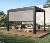 A modern freestanding aluminum pergola with a retractable privacy screen, creating a shaded outdoor lounge area on a wooden deck in a landscaped backyard.