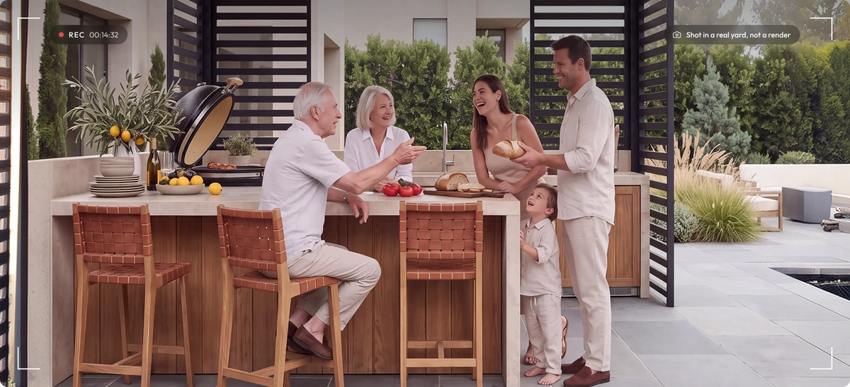 Family enjoying an outdoor kitchen under a Hansø pergola